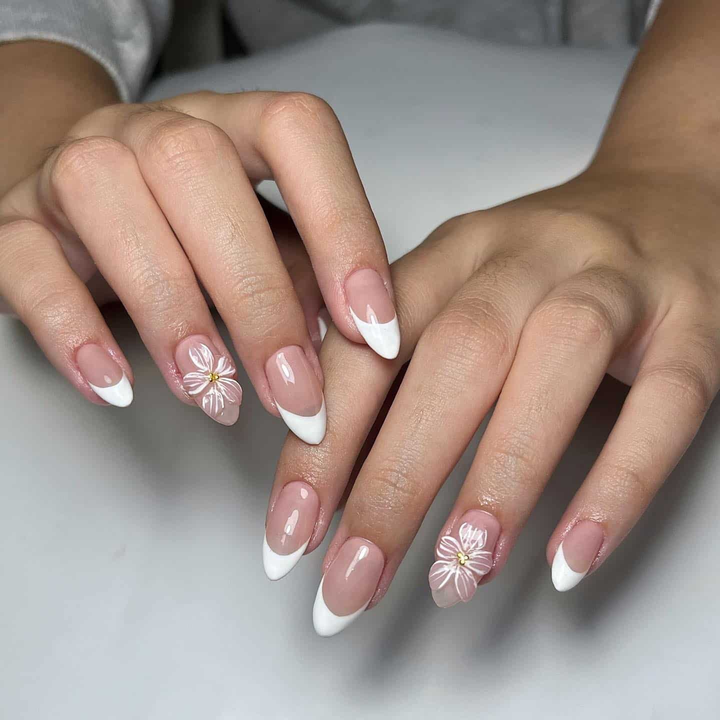 1. Soft Pink Almond French with White Floral Accent - classy almond nail ideas