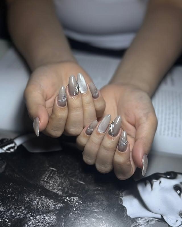 8. Taupe Chrome Almond with Crystal Embellishments - classy almond nail ideas