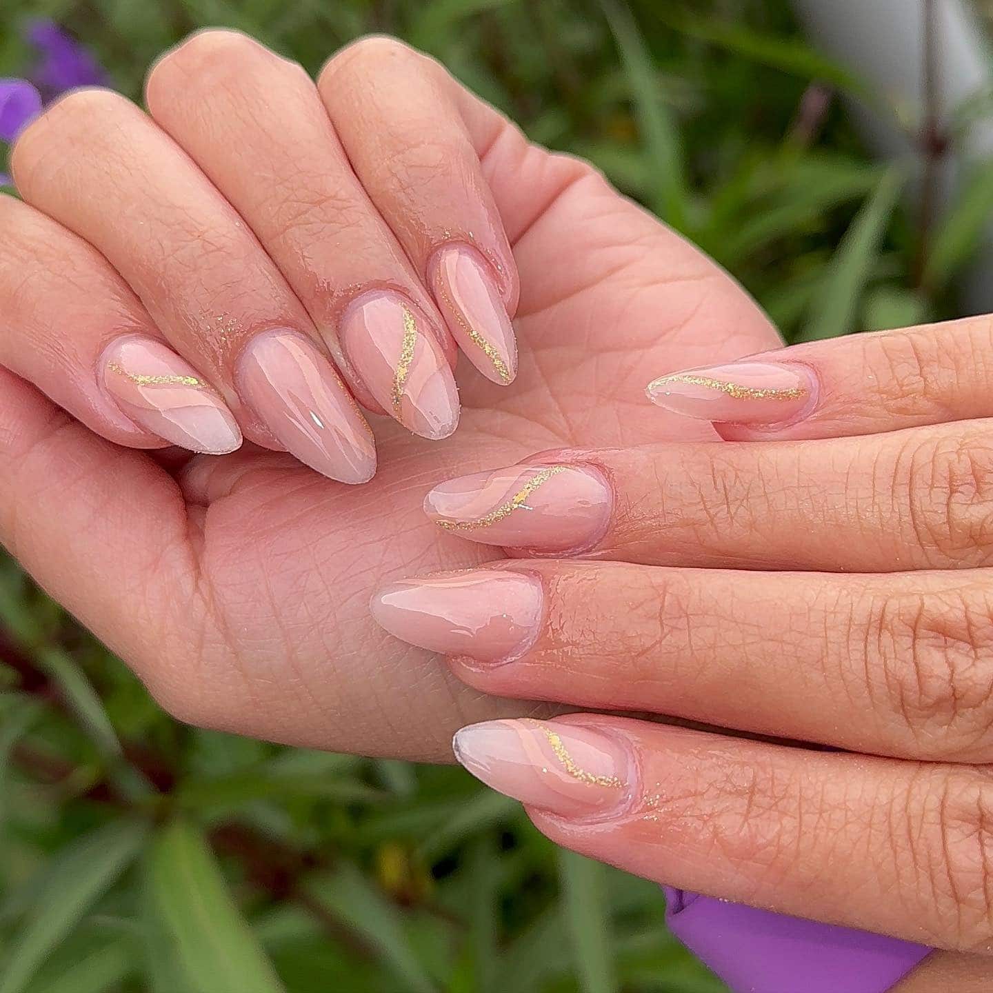 12. Sheer Nude Almond with Gold Glitter Waves - classy almond nail ideas