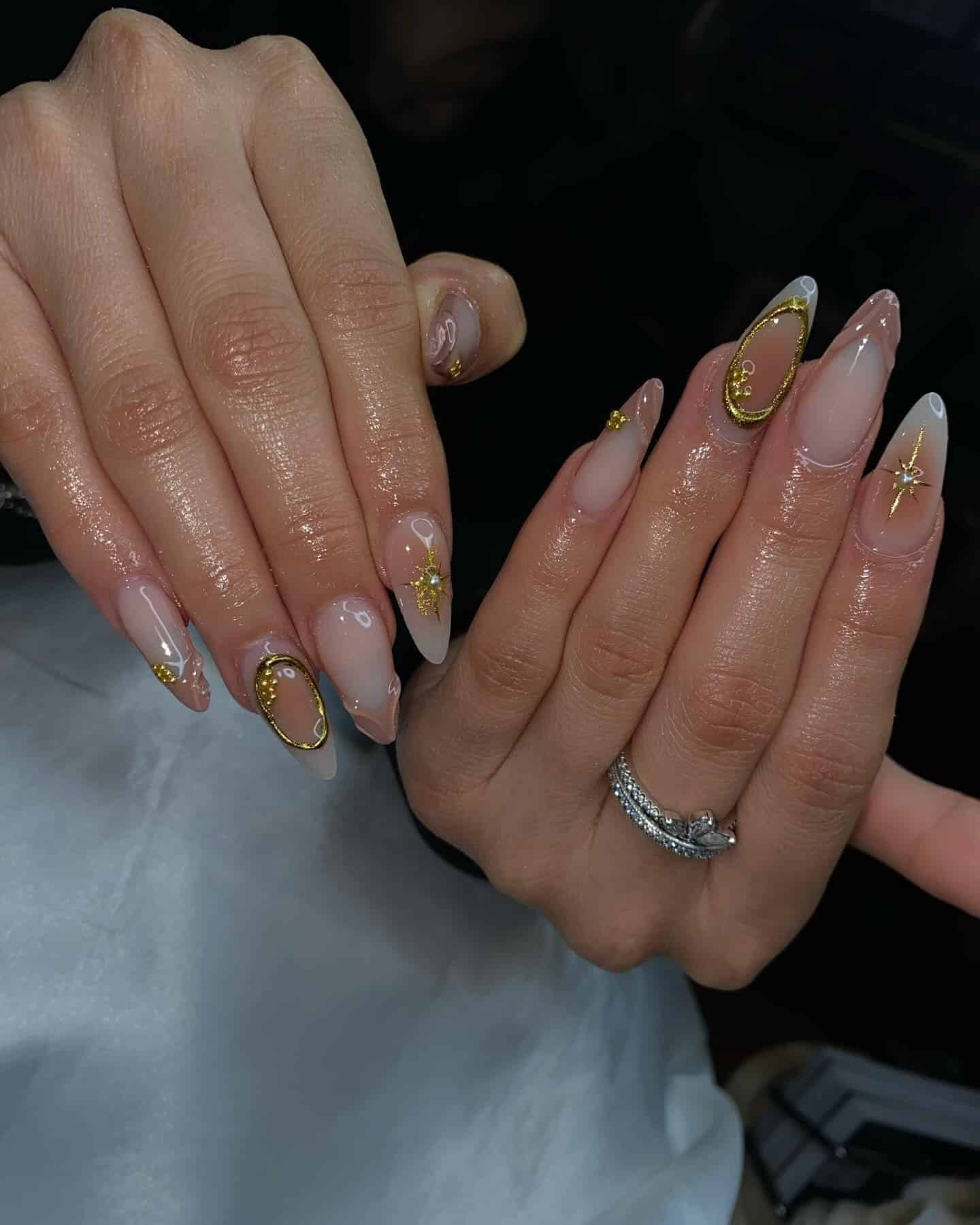 14. Blush Almond with Gold Frame and Starburst Details - classy almond nail ideas