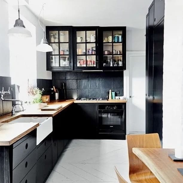 4. Compact Black Kitchen with Butcher Block Countertops - black kitchen cabinets ideas