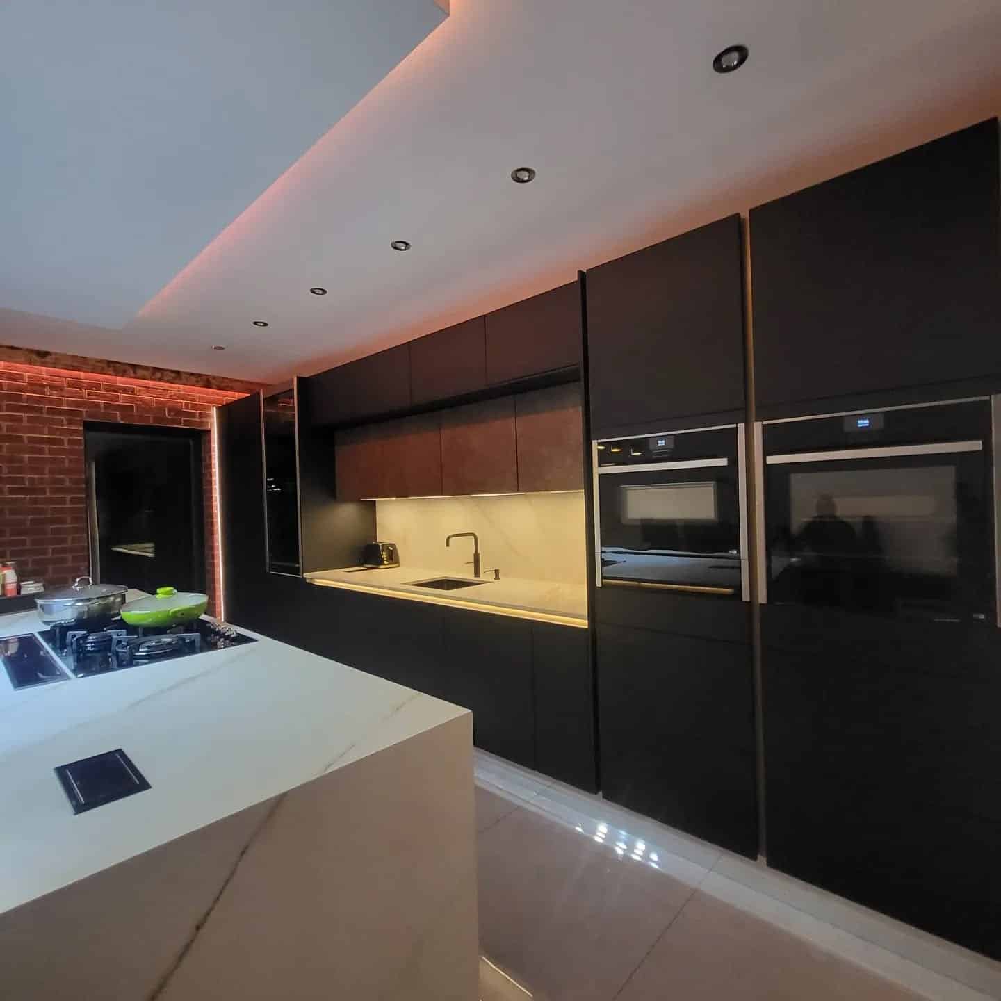 8. Moody Black Kitchen with Ambient LED Lighting - black kitchen cabinets ideas