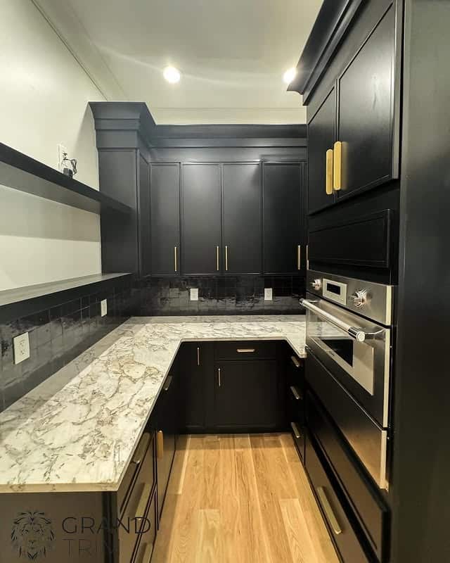 15. Modern U-Shaped Black Kitchen with Marble Countertops - black kitchen cabinets ideas