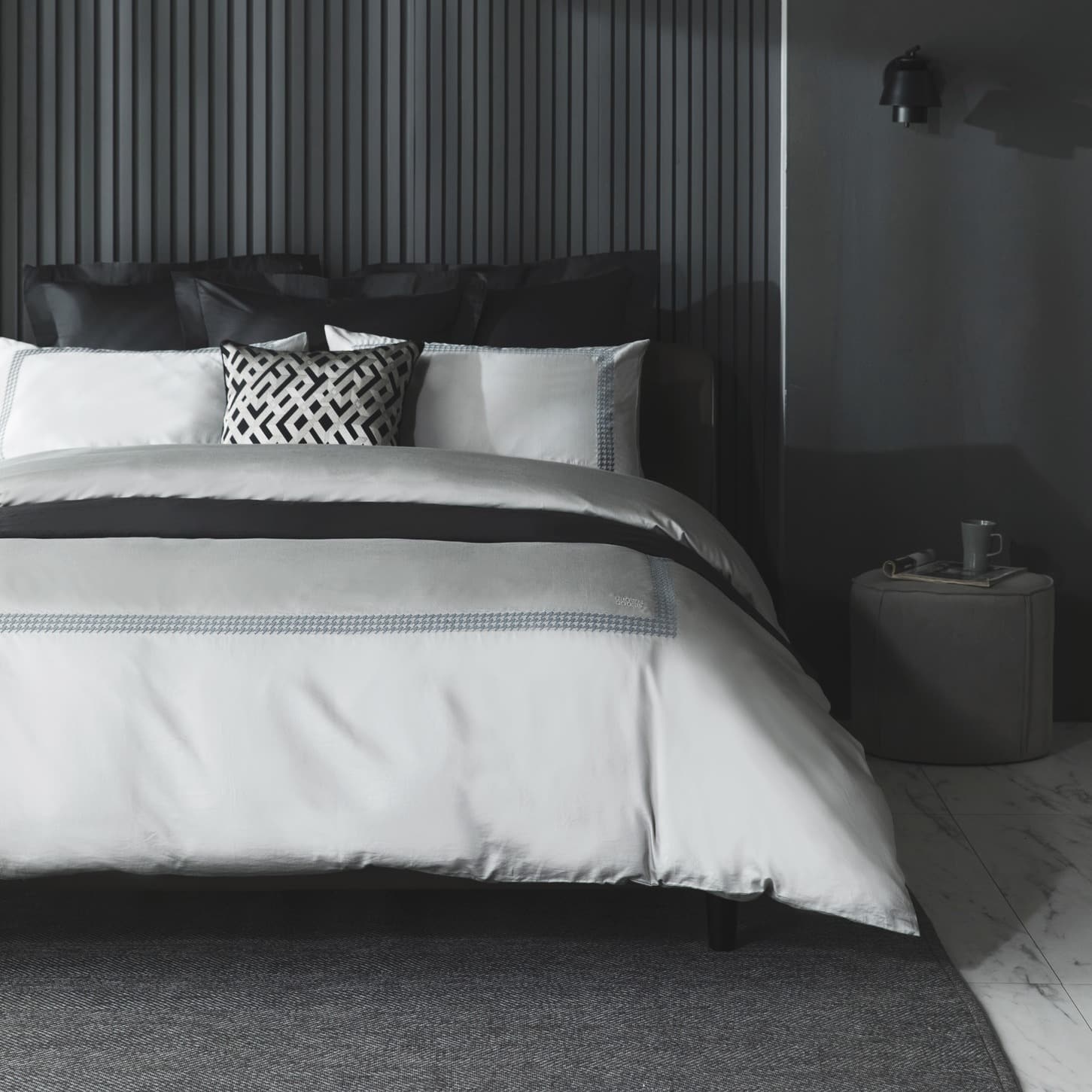6. Textured Gray Bedroom with Layered Bedding Contrast - black and gray bedroom ideas