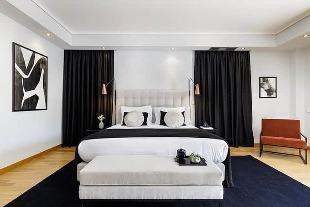 9. Hotel-Inspired Black and Gray Bedroom with Dramatic Drapery - black and gray bedroom ideas