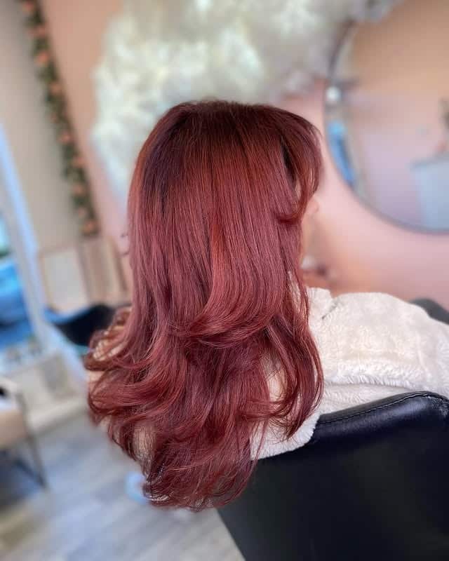 6. Warm Cherry Red Soft Layers - Dark Red Hair Color