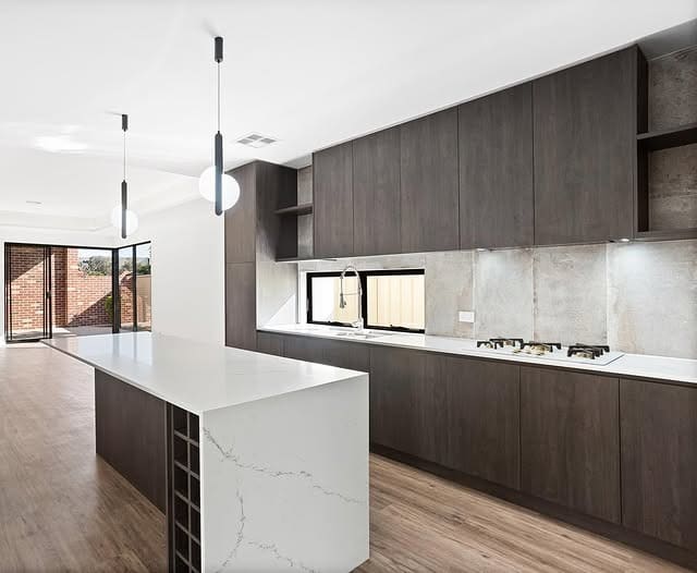 15. Smoked Oak Flat-Panel Cabinets with Minimalist White Island - dark kitchen cabinet ideas