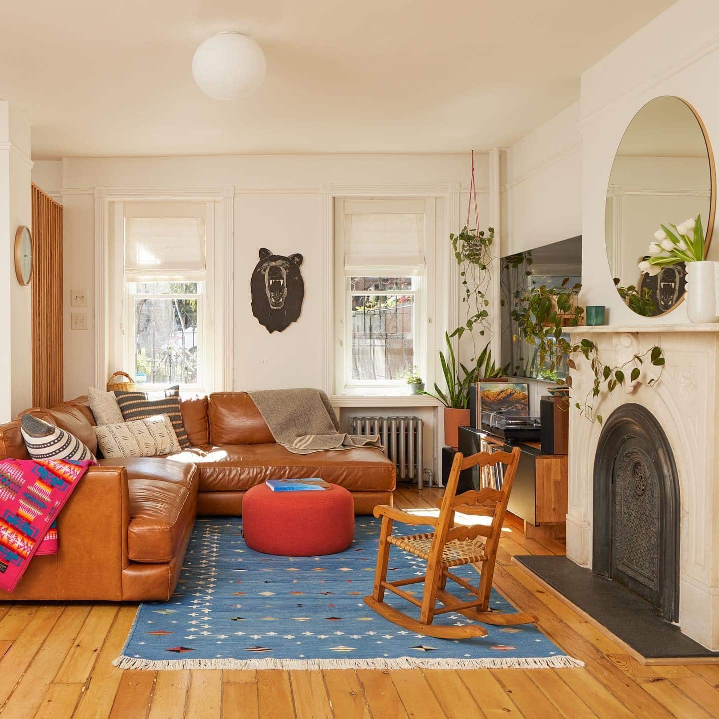 7. Eclectic Urban Living Room with Cognac Leather and Rich Blue - cozy living room ideas