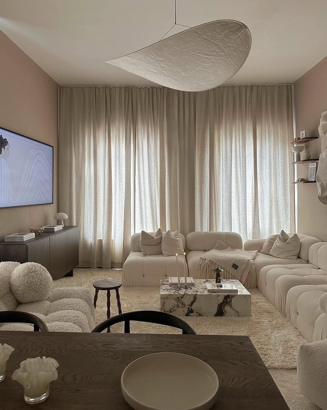 9. Contemporary Cream Living Room with Marble and Soft Textures - cozy living room ideas