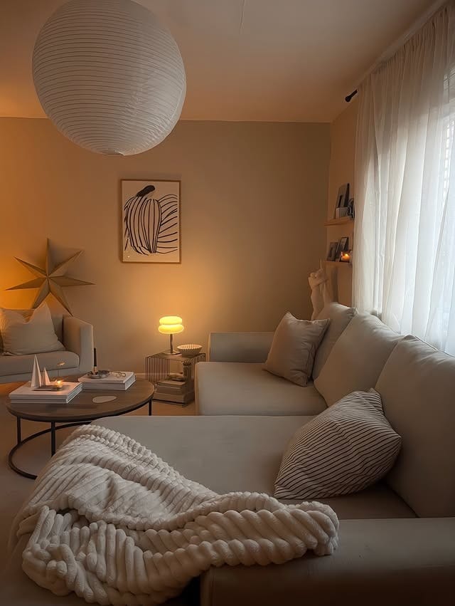 13. Soft Neutral Living Room with Warm Ambient Lighting - cozy living room ideas