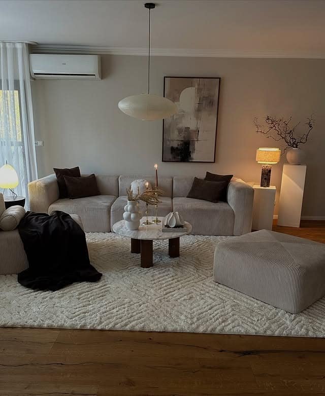 19. Minimalist Beige Living Room with Sculpted Forms - cozy living room ideas