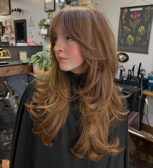 6. Honey Brown Feathered Shag with Long Curtain Bangs - Medium Length Shag Hairstyles