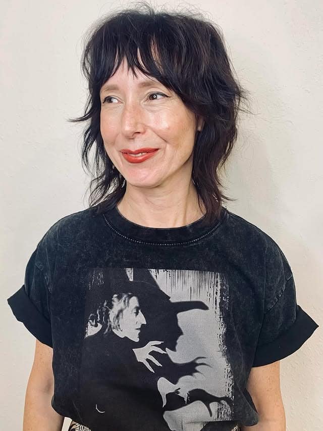 17. Midnight Brunette Textured Shag with Wispy Fringe - Medium Length Shag Hairstyles