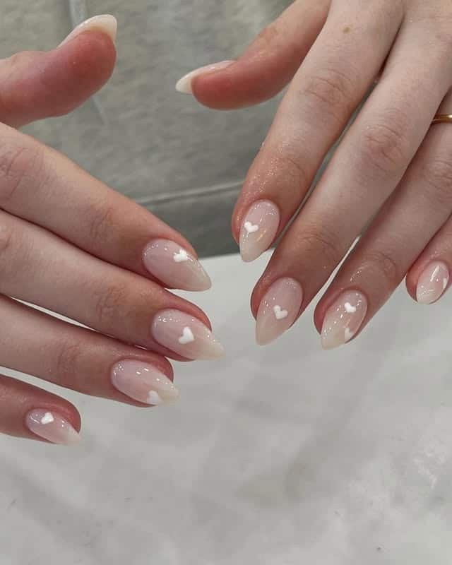 1. Milky Blush Almond Nails with White Heart Accents - elegant bridal nail ideas