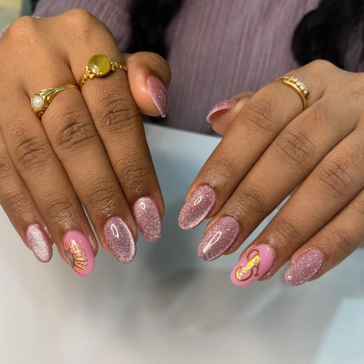 20. Blush Pink Glitter Almond Nails with Gold Monogram Accent - elegant bridal nail ideas