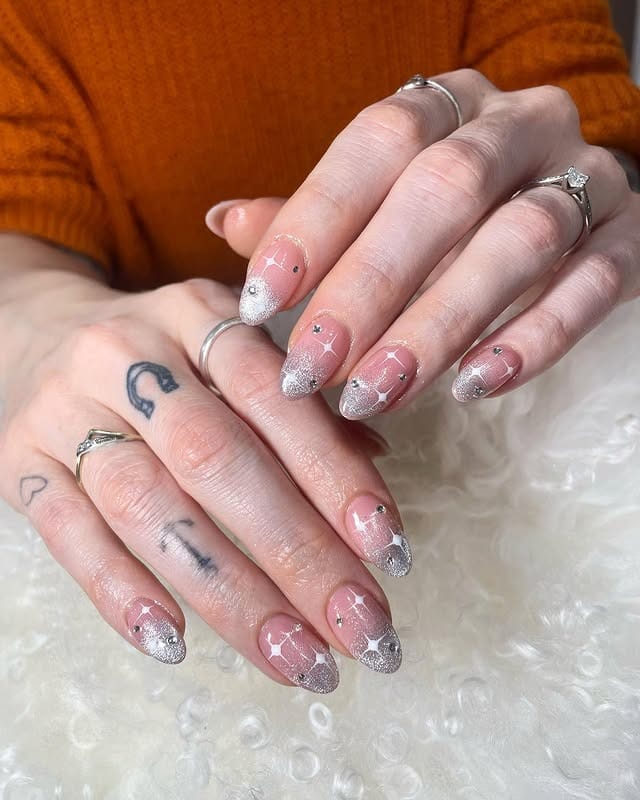22. Sheer Pink Almond Nails with Silver Glitter Ombre and Star Accents - elegant bridal nail ideas