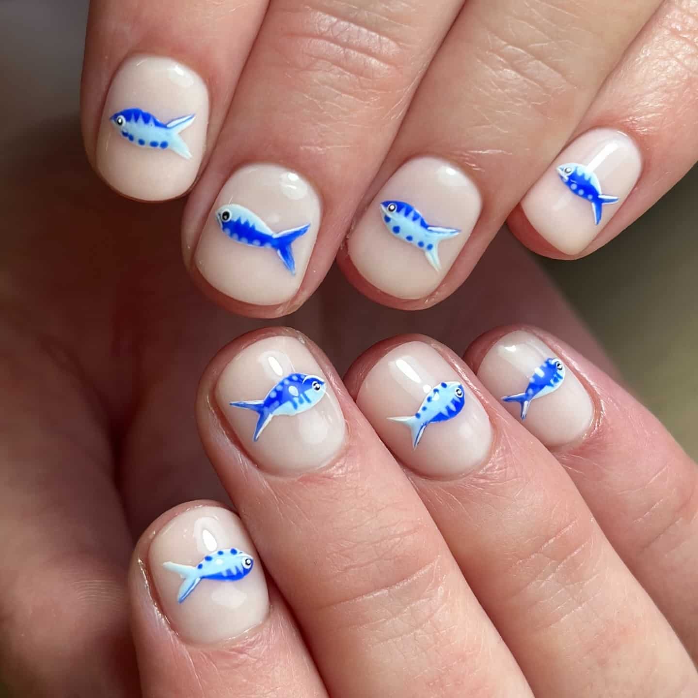 20. Milky Beige Short Nails with Blue Sardine Art - fish nail ideas