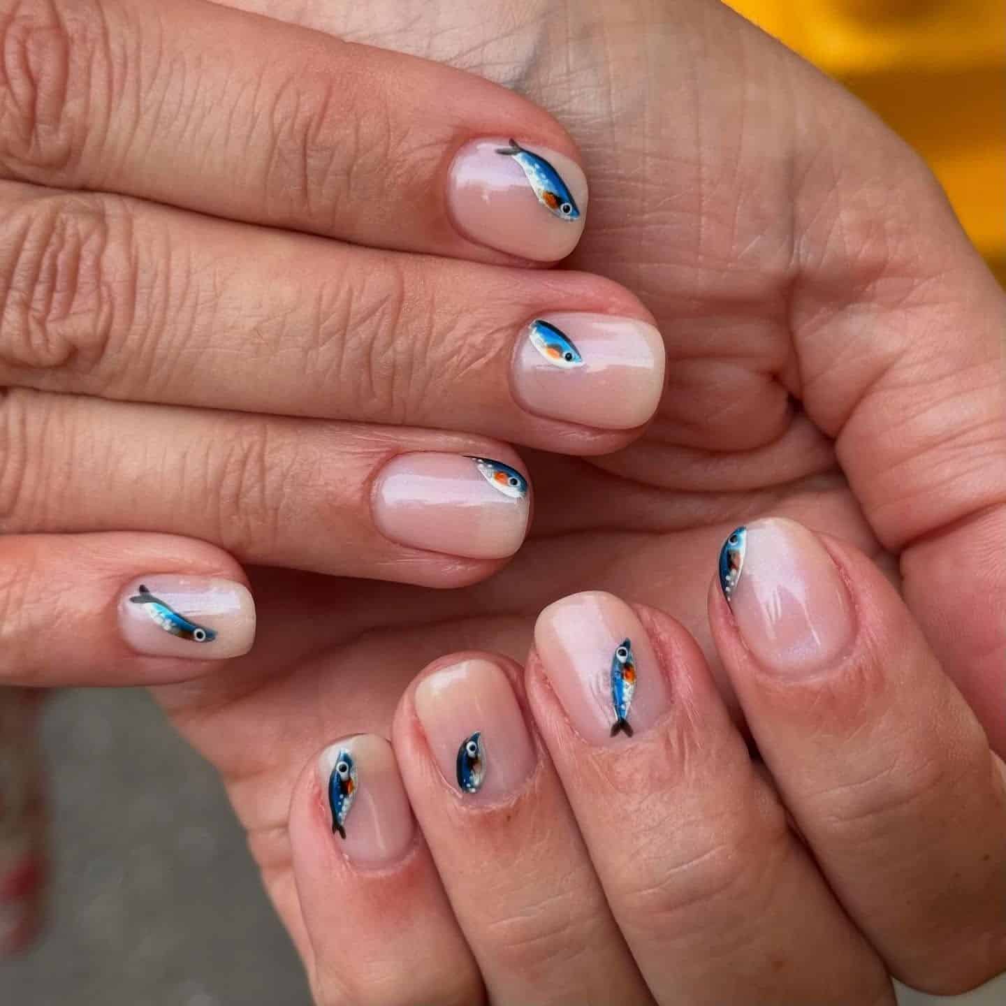 21. Milky Nude Short Nails with Realistic Sardine Art - fish nail ideas