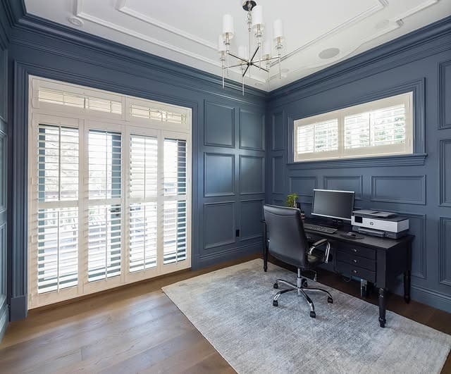 2. Deep Blue Paneled Study with Crisp White Trim - masculine home office ideas