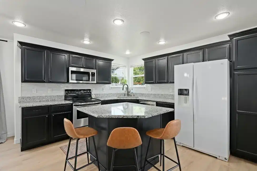 8. Black Cabinets with Granite Counters and Bright White Walls - black cabinets kitchen ideas