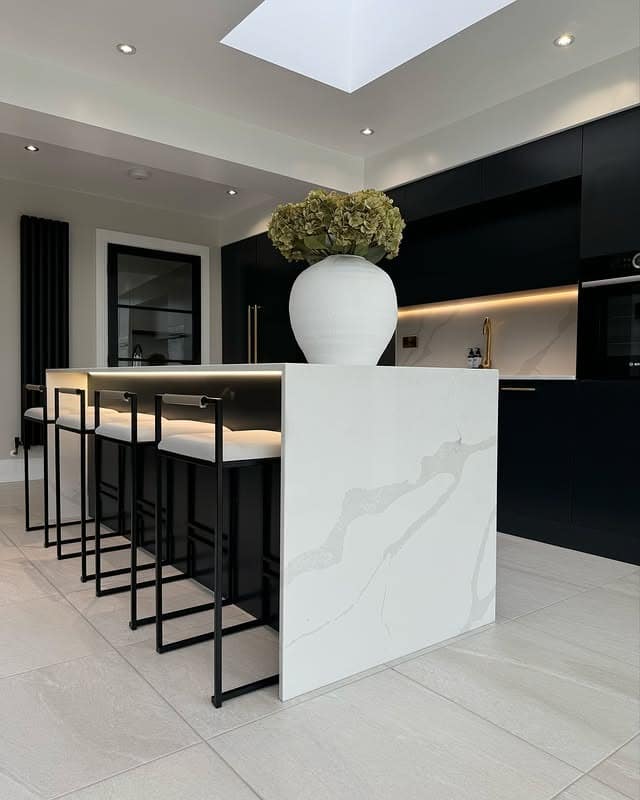 13. Minimal Black Handleless Kitchen with White Quartz Island - black cabinets kitchen ideas