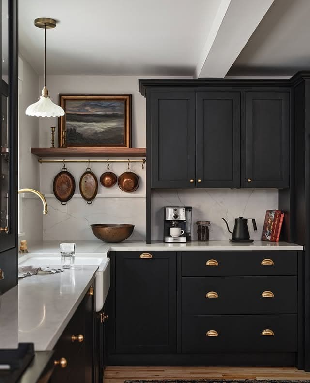 15. Traditional Black Cabinets with Brass Cup Pulls - black cabinets kitchen ideas