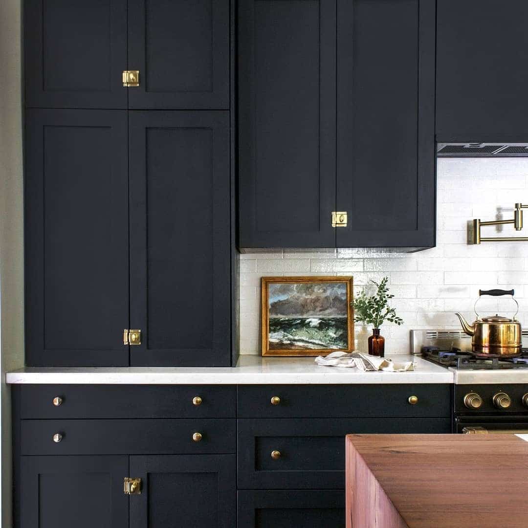 21. Navy-Black Shaker Cabinets with Brass Hardware - black cabinets kitchen ideas
