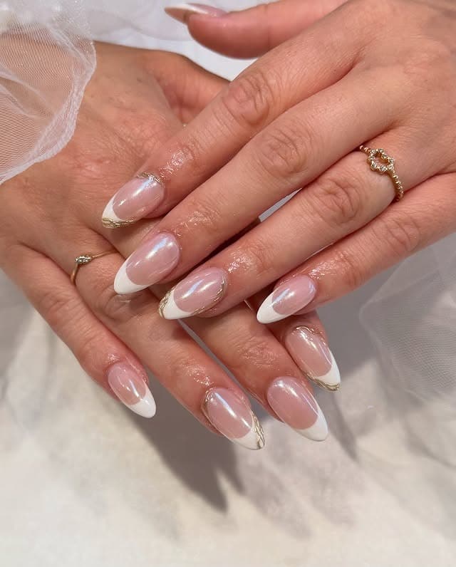9. Pearlescent White French with Gold Lining - formal nail ideas