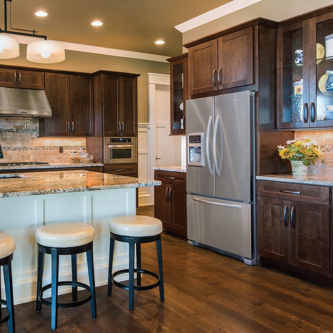 12. Warm Chestnut Cabinets with Creamy Island Base - brown kitchen cabinets ideas