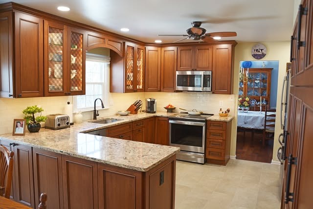 13. Cinnamon Brown Cabinets with Decorative Glass Panels - brown kitchen cabinets ideas