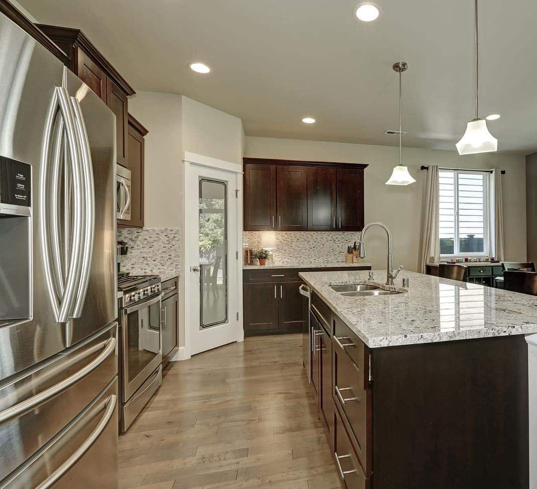 14. Dark Mocha Cabinets with Bright Quartz Surfaces - brown kitchen cabinets ideas