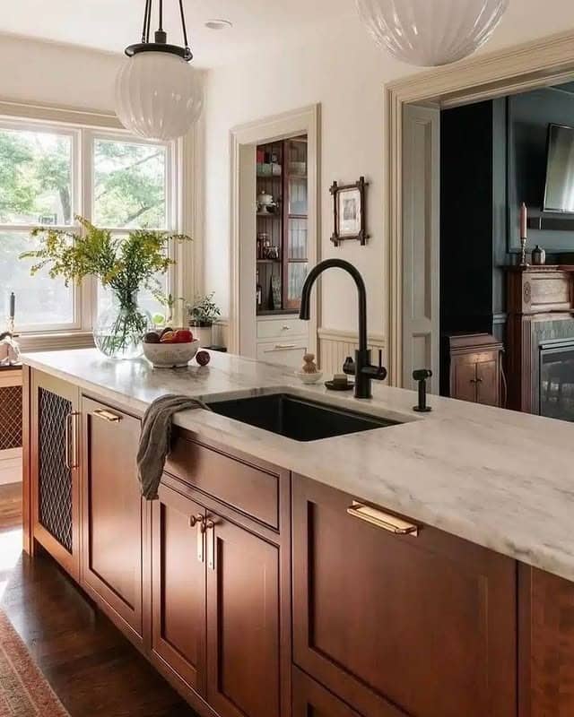 20. Classic Brown Cabinets with Marble-Topped Island and Brass Details - brown kitchen cabinets ideas