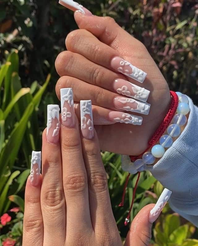 15. Extra Long Square French with Raised White Floral Sculpting - french tip flower nail ideas