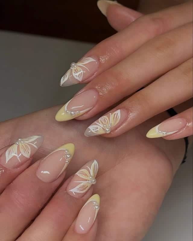 22. Almond Yellow French with White Floral Line Art - french tip flower nail ideas
