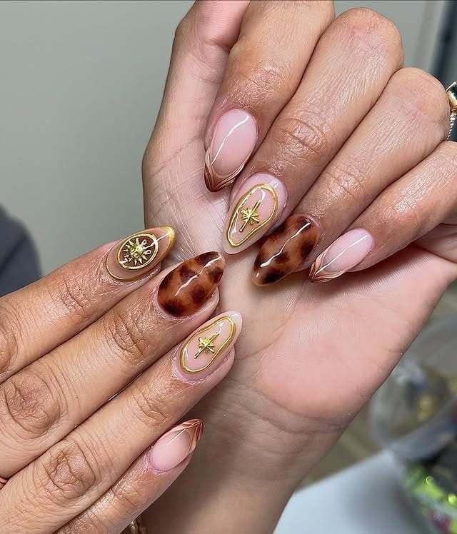 10. Nude and Tortoiseshell Almond Nails with Gold Star Accents - gold and brown nail ideas