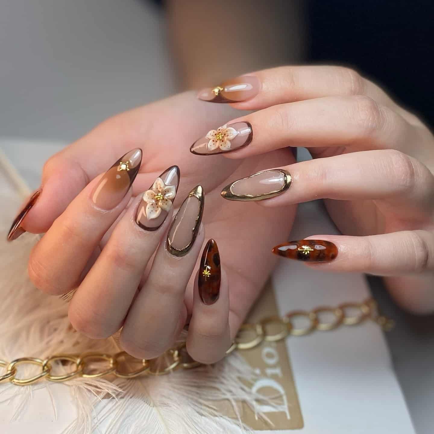 14. Mocha and Tortoiseshell Almond Nails with 3D Floral Art - gold and brown nail ideas