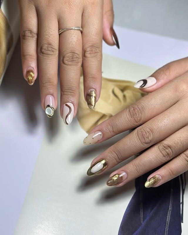 17. Minimalist Nude and Brown Swirl Nails with Gold Foil Accents - gold and brown nail ideas