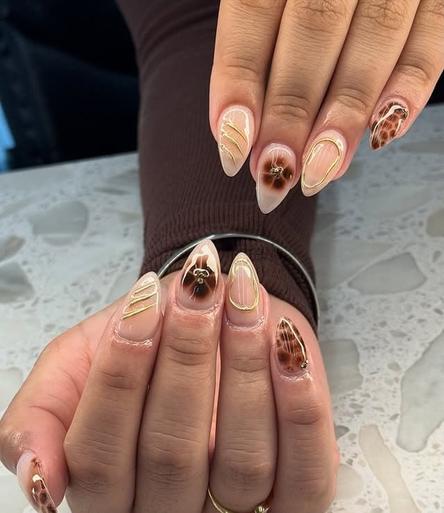 19. Short Nude Almond Nails with Tortoiseshell and Gold Striping - gold and brown nail ideas