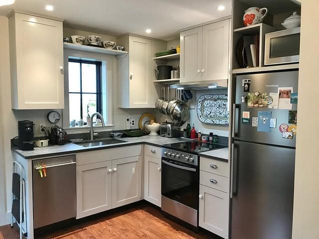 9. Efficient White U-Shaped Garage Kitchen with Stainless Accents - garage kitchen ideas