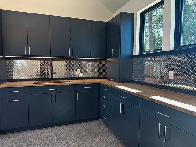 21. Industrial Navy Garage Kitchen with Stainless Steel Backsplash - garage kitchen ideas
