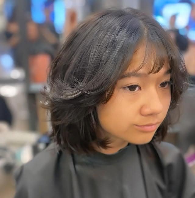 22. Charcoal Black Textured Layered Bob with Wispy Fringe - Layered Bob Hairstyles