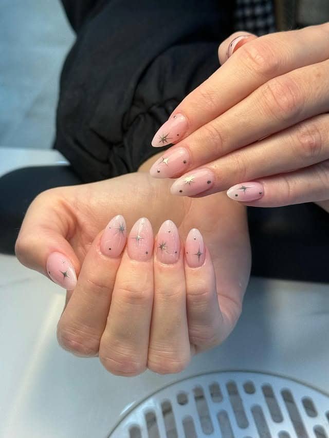 6. Sheer Pink Almond Nails with Silver-Gold Star Accents - gold chrome nail ideas