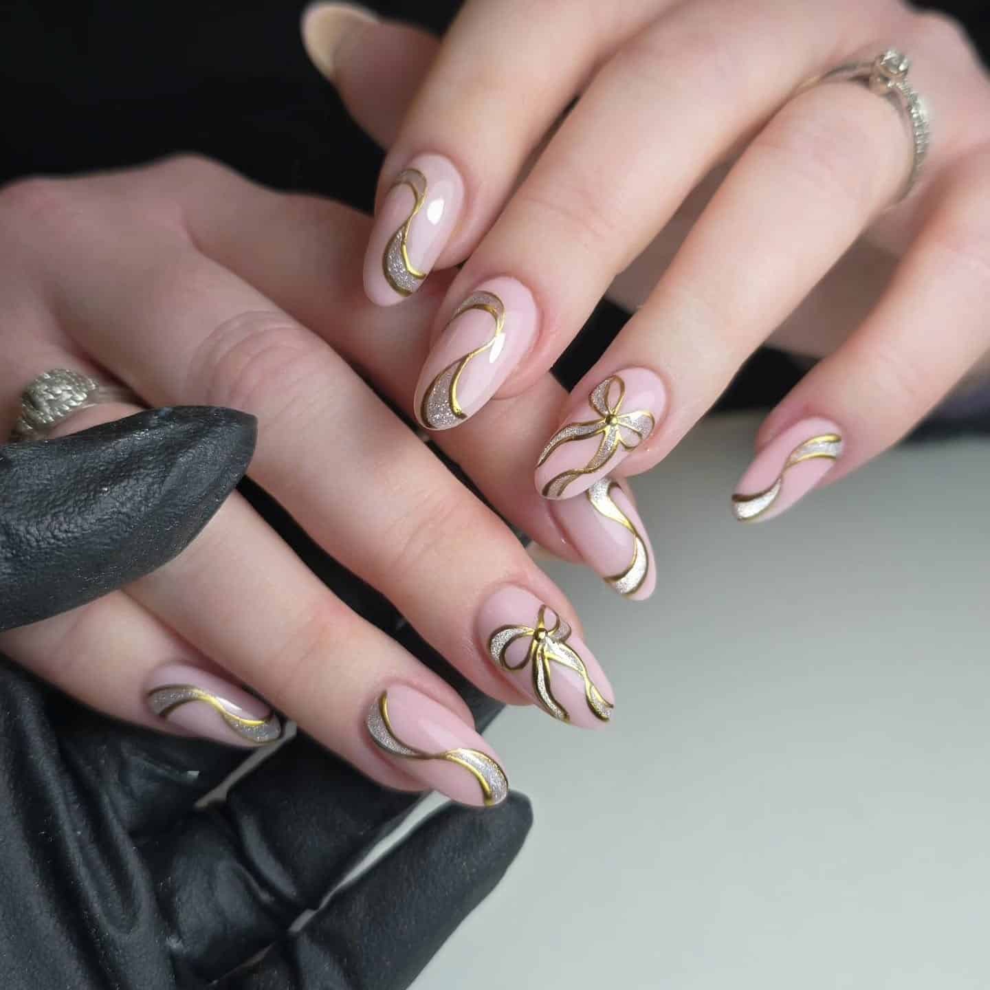 9. Nude Almond Nails with Gold Ribbon Chrome Detailing - gold chrome nail ideas