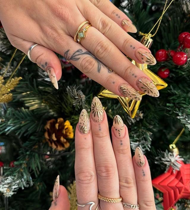 10. Champagne Nude Almond Nails with Gold Foil Starbursts - gold chrome nail ideas