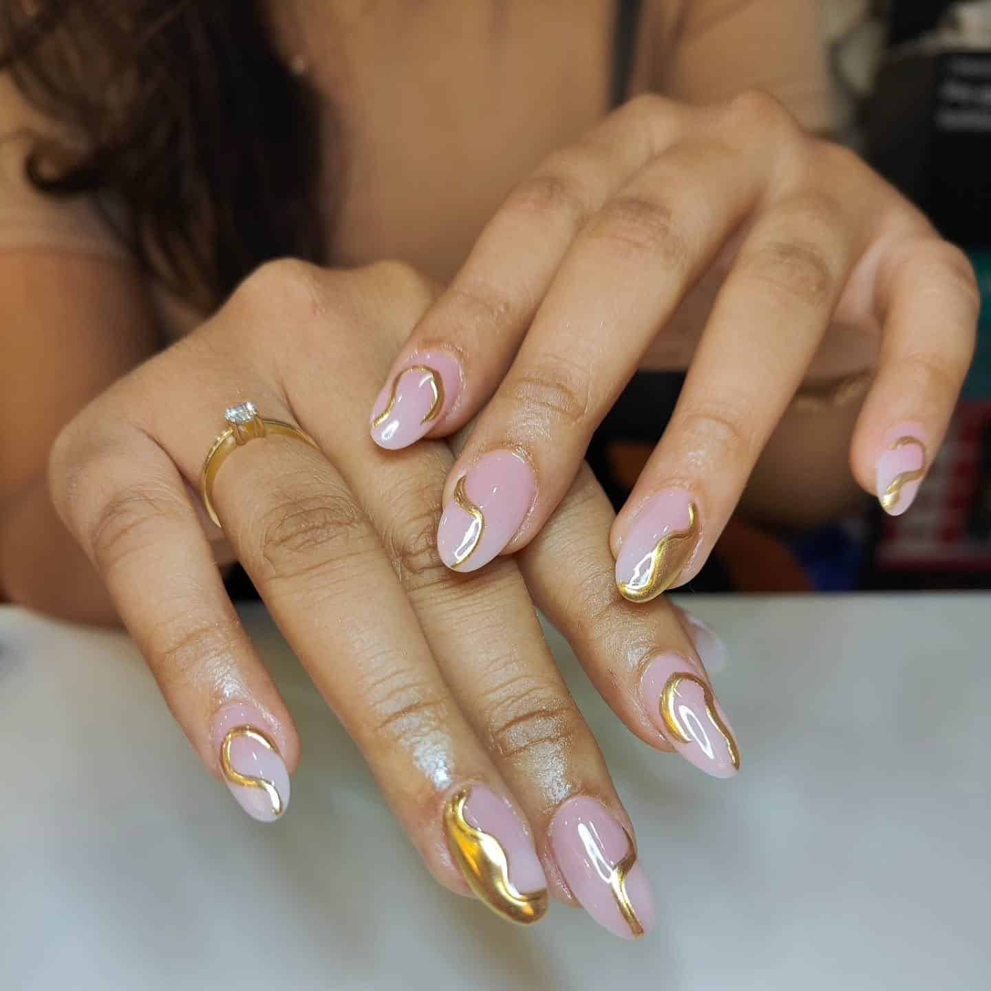 13. Blush Oval Nails with Molten Gold Chrome Waves - gold chrome nail ideas