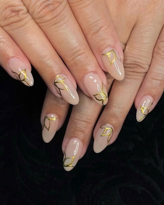 16. Nude Almond Nails with Gold Chrome Leaf Line Art - gold chrome nail ideas