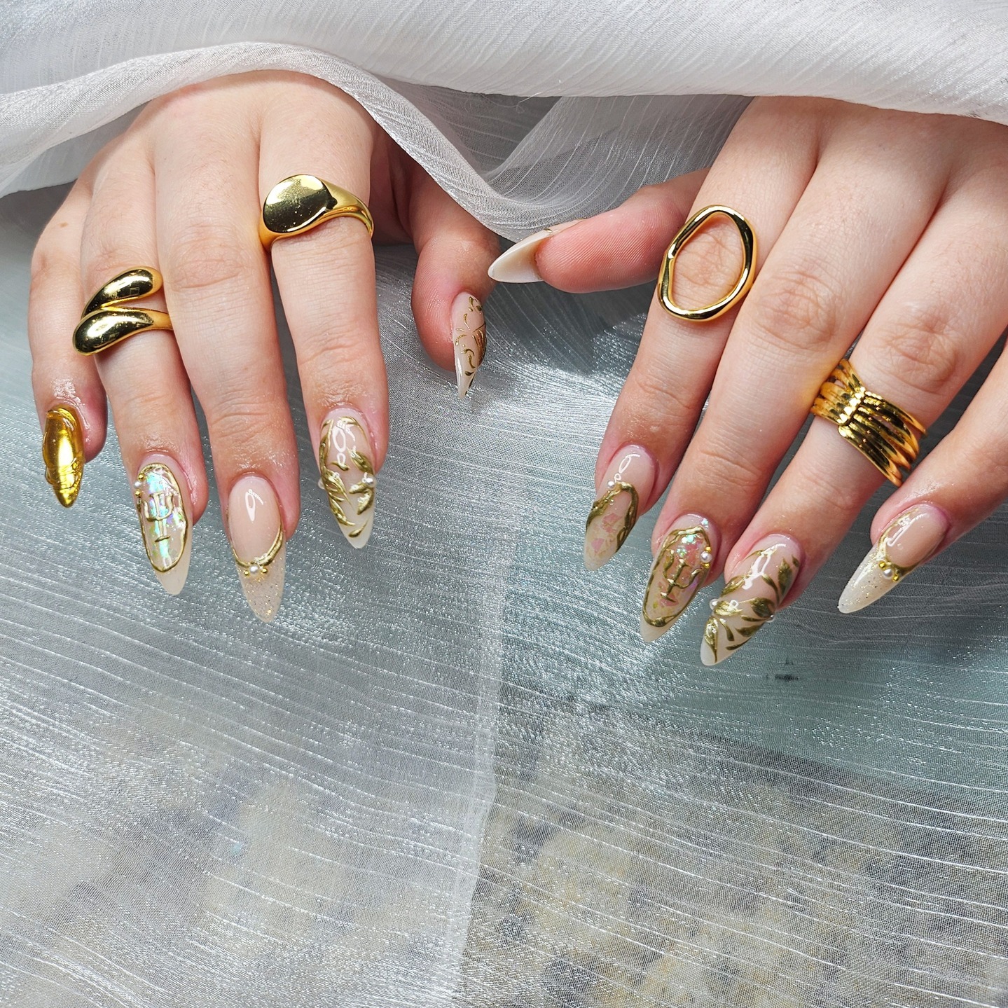 21. Nude Stiletto Nails with Gold Chrome Botanical Art - gold chrome nail ideas