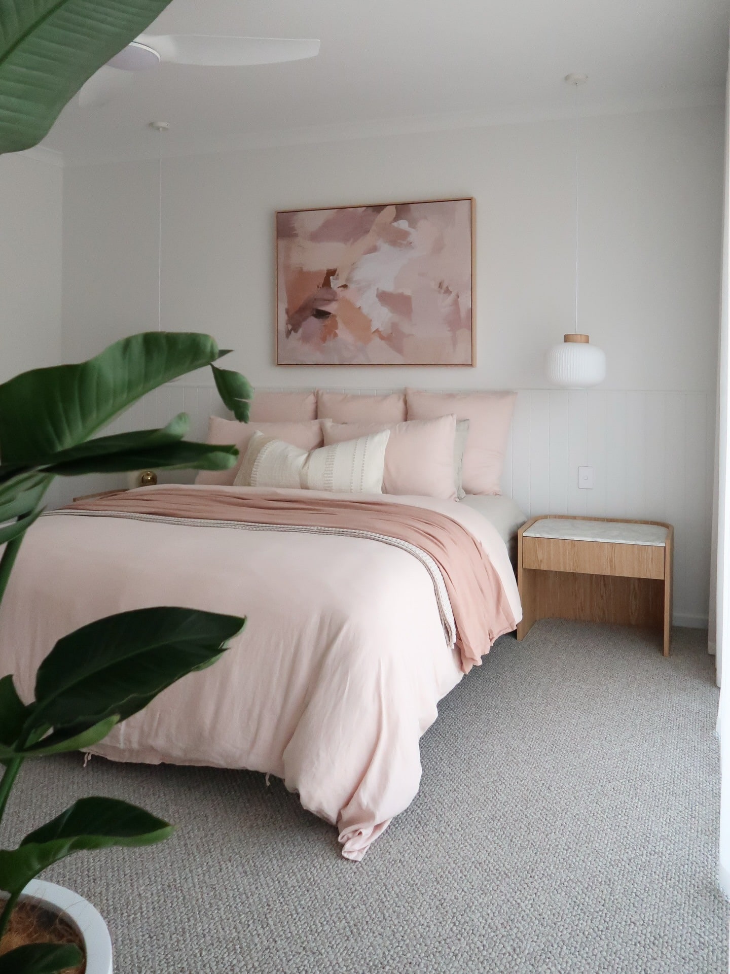 7. Blush Abstract Art with Crisp White Backdrop - pink and white bedroom ideas