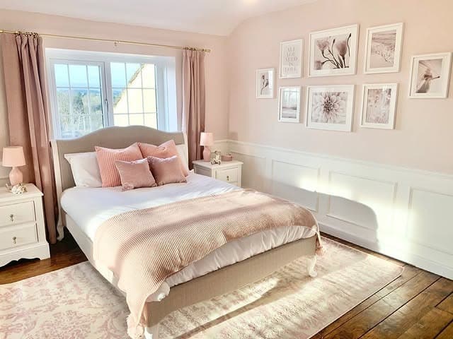 20. Classic Paneling with Blush Accents and White Trim - pink and white bedroom ideas