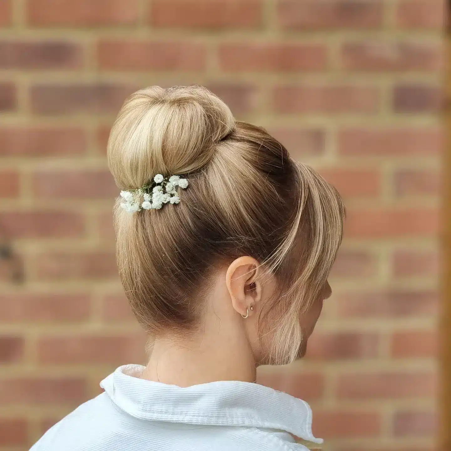 1. Classic Blonde High Bun with Soft Face-Framing Layers - Bridesmaid Hairstyles
